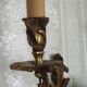 Apply two bronze wall lights decorated with acanthus leaves.