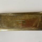 Bronze pocket emptier with fish decoration.