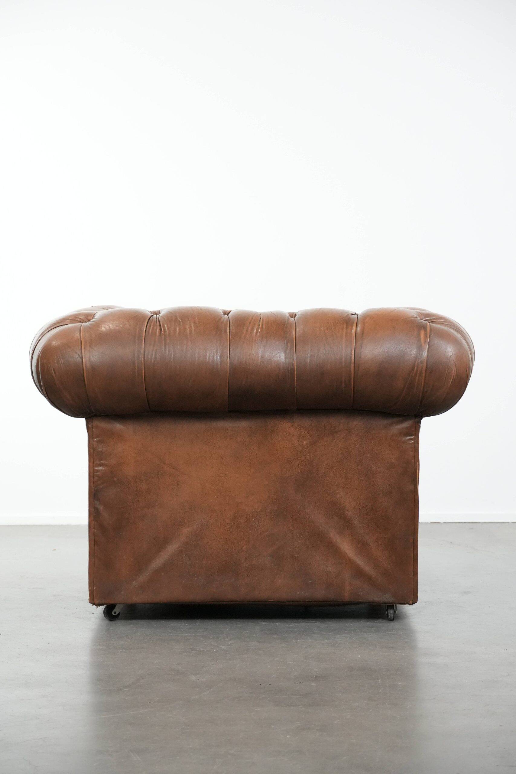 Brown cowhide leather chesterfield armchair  in English style on wheels