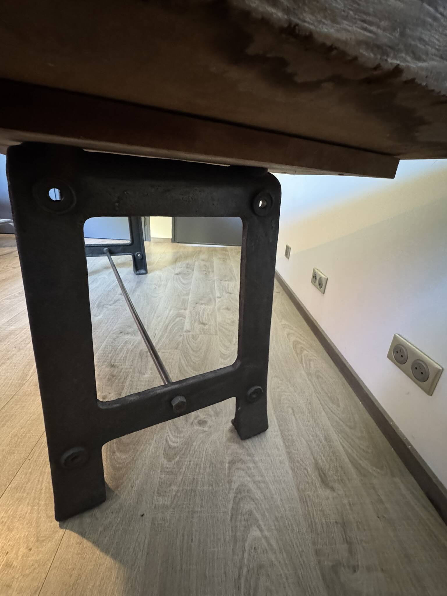 Industrial style table with a mahogany top.