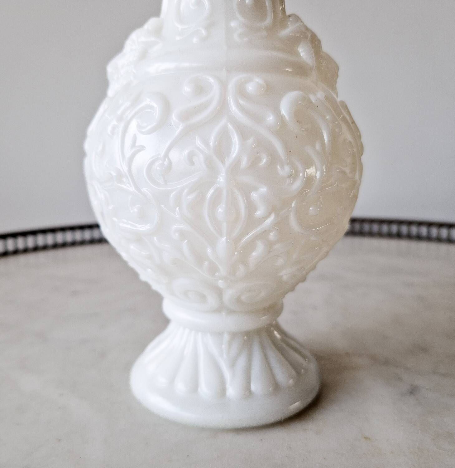 White opaline vase decorated with arabesques and ram's heads