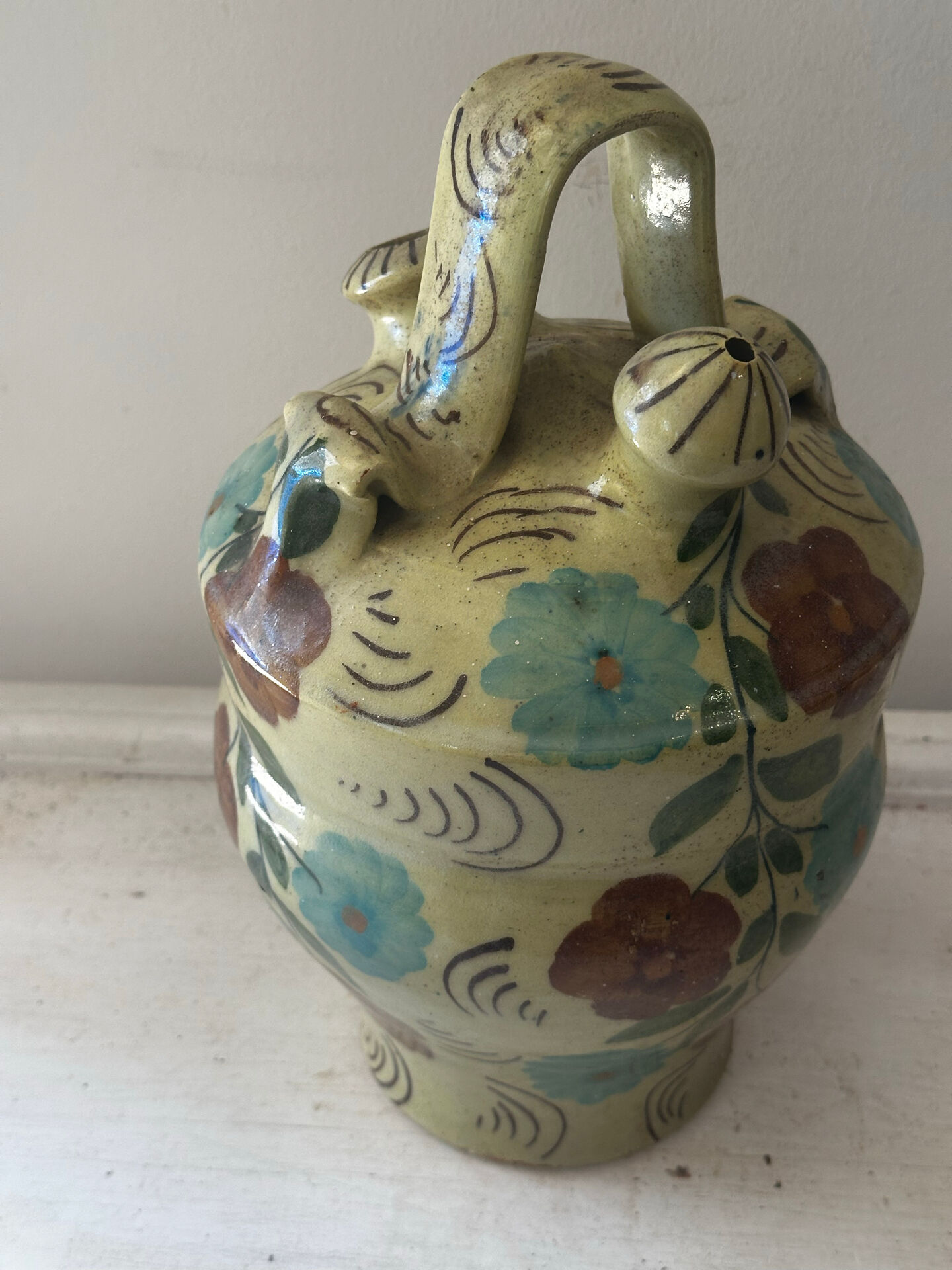 Mediterranean ceramic jug with floral decoration.