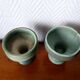 Pair of Belgian ceramic candlesticks on feet