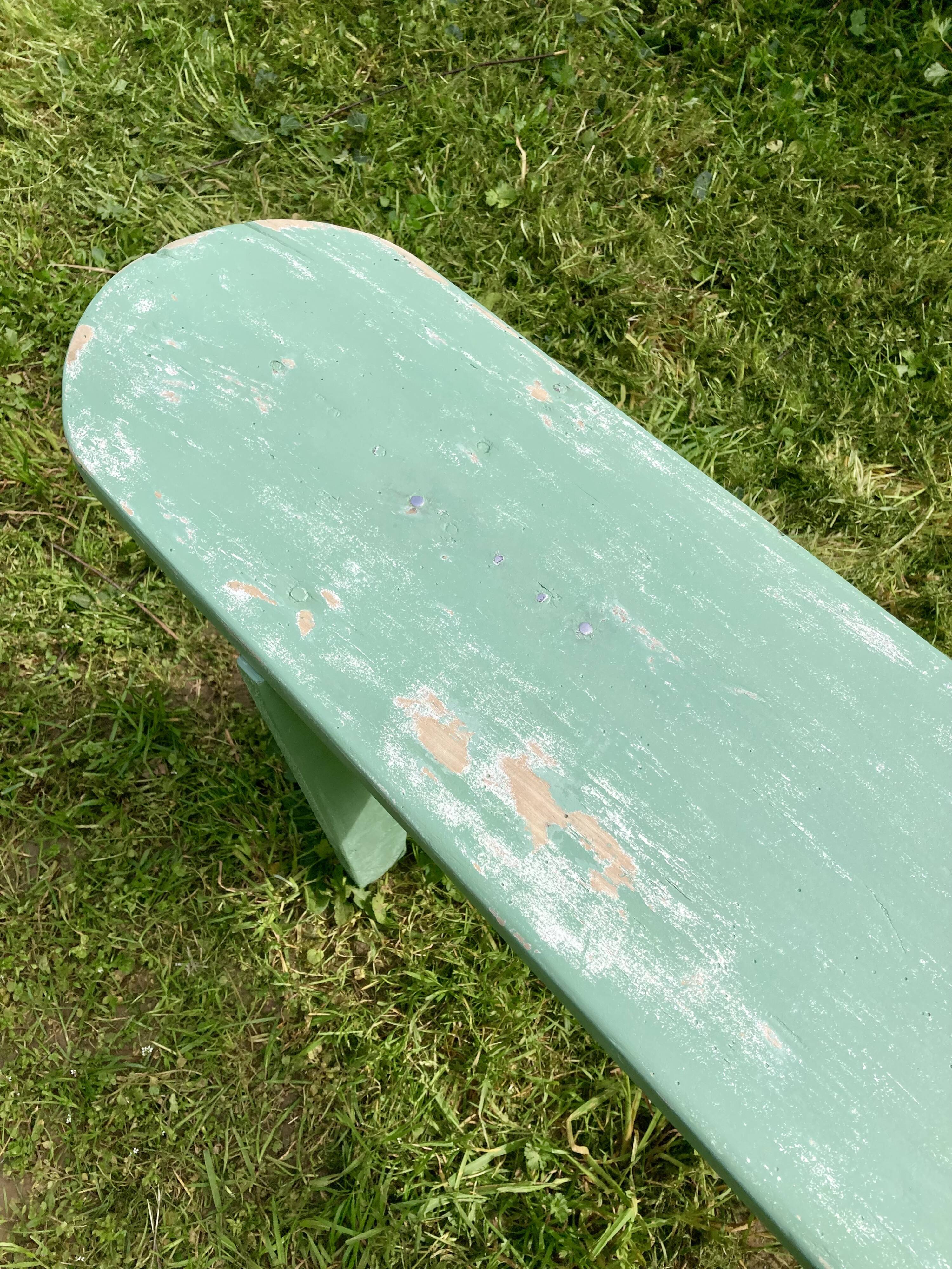 Old curved wooden farm bench