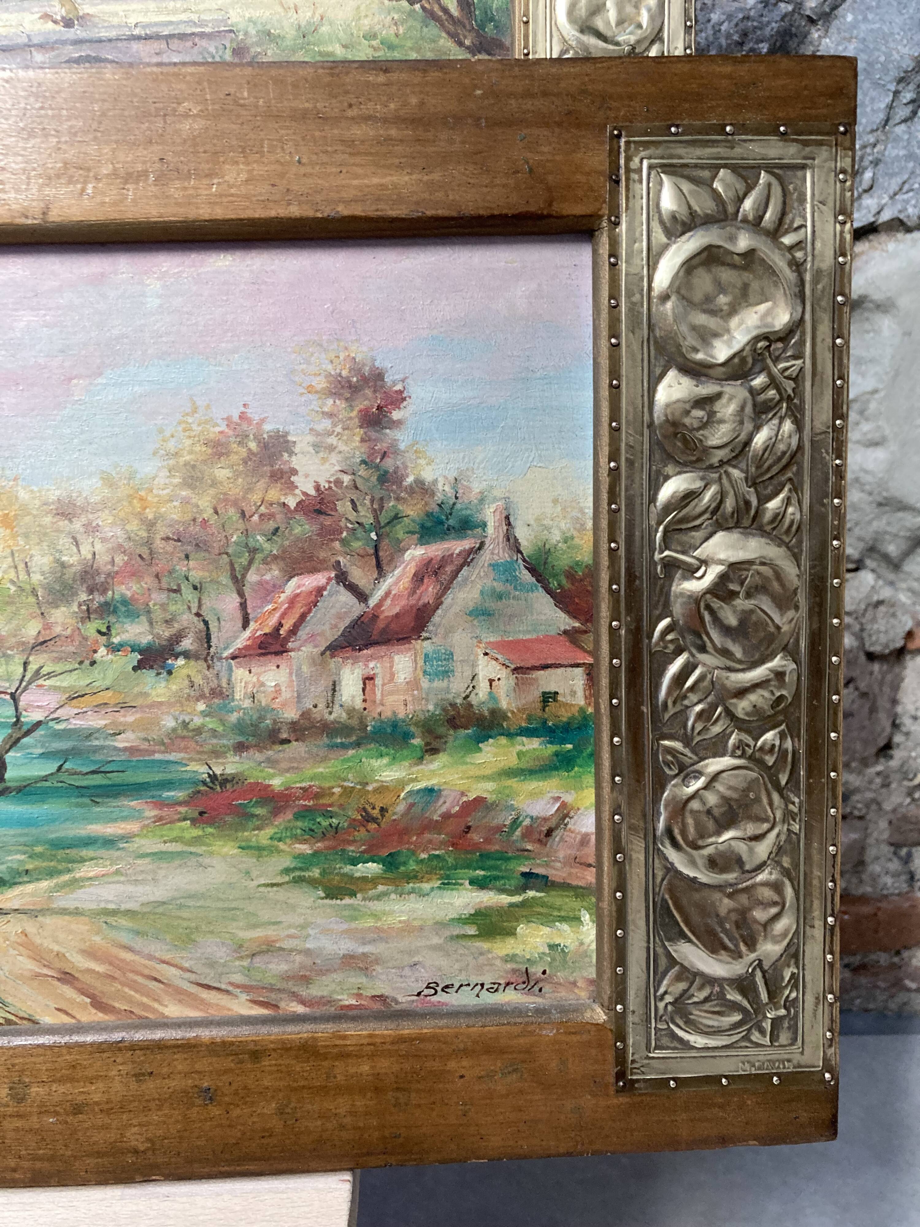 Pair of Art Deco wood and embossed metal landscape frames