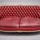 Louis XV style basket canapé with a curved back, upholstered in leather.
