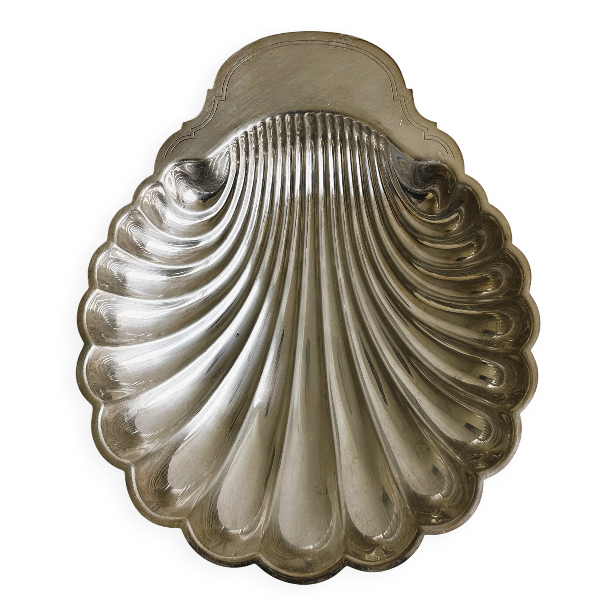 large silver-plated metal shell-shaped dish