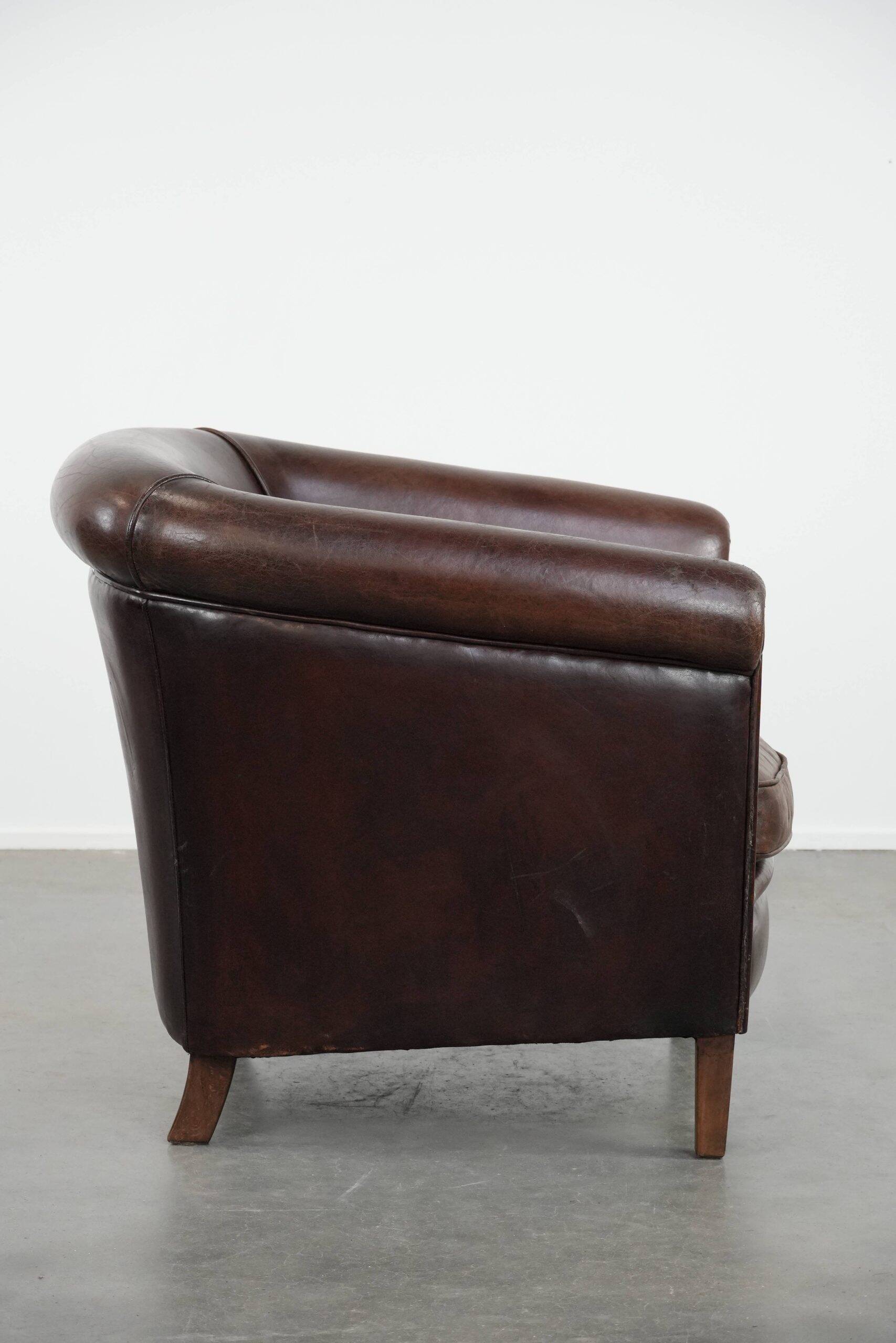 Stylish and sturdy dark brown club armchair made of sheepskin leather