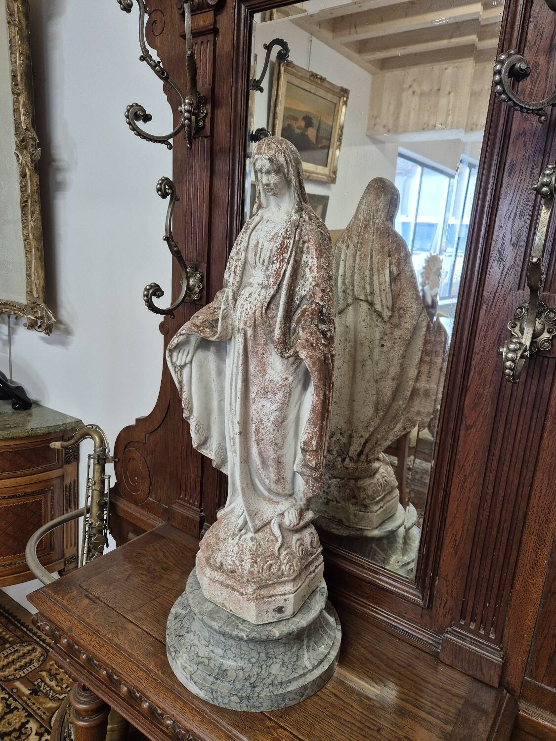 Garden statue of the Virgin Mary in old reconstituted stone