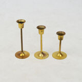 A set of three golden candlesticks, 1970s