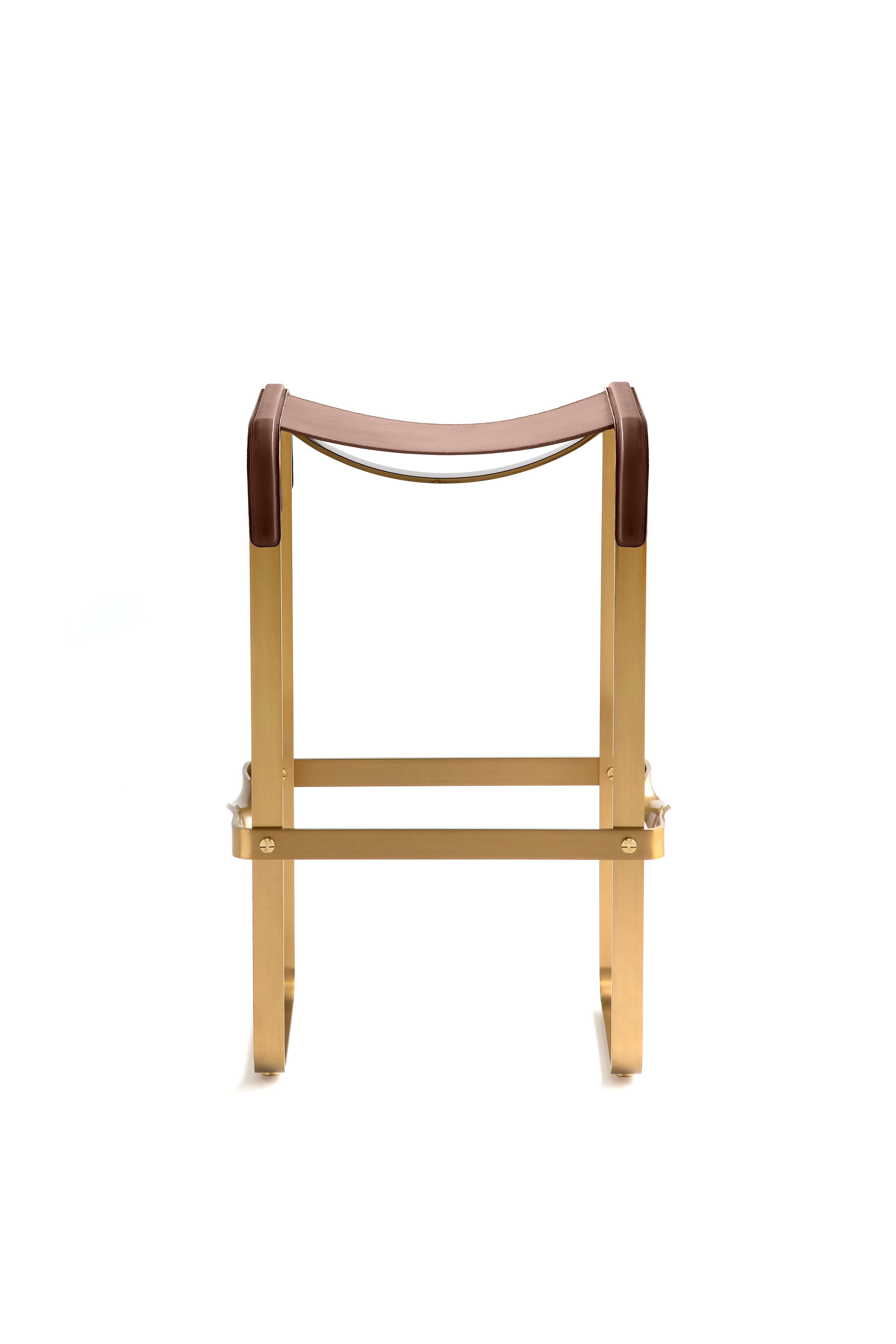 Contemporary kitchen stool, aged brass metal and cognac leather.