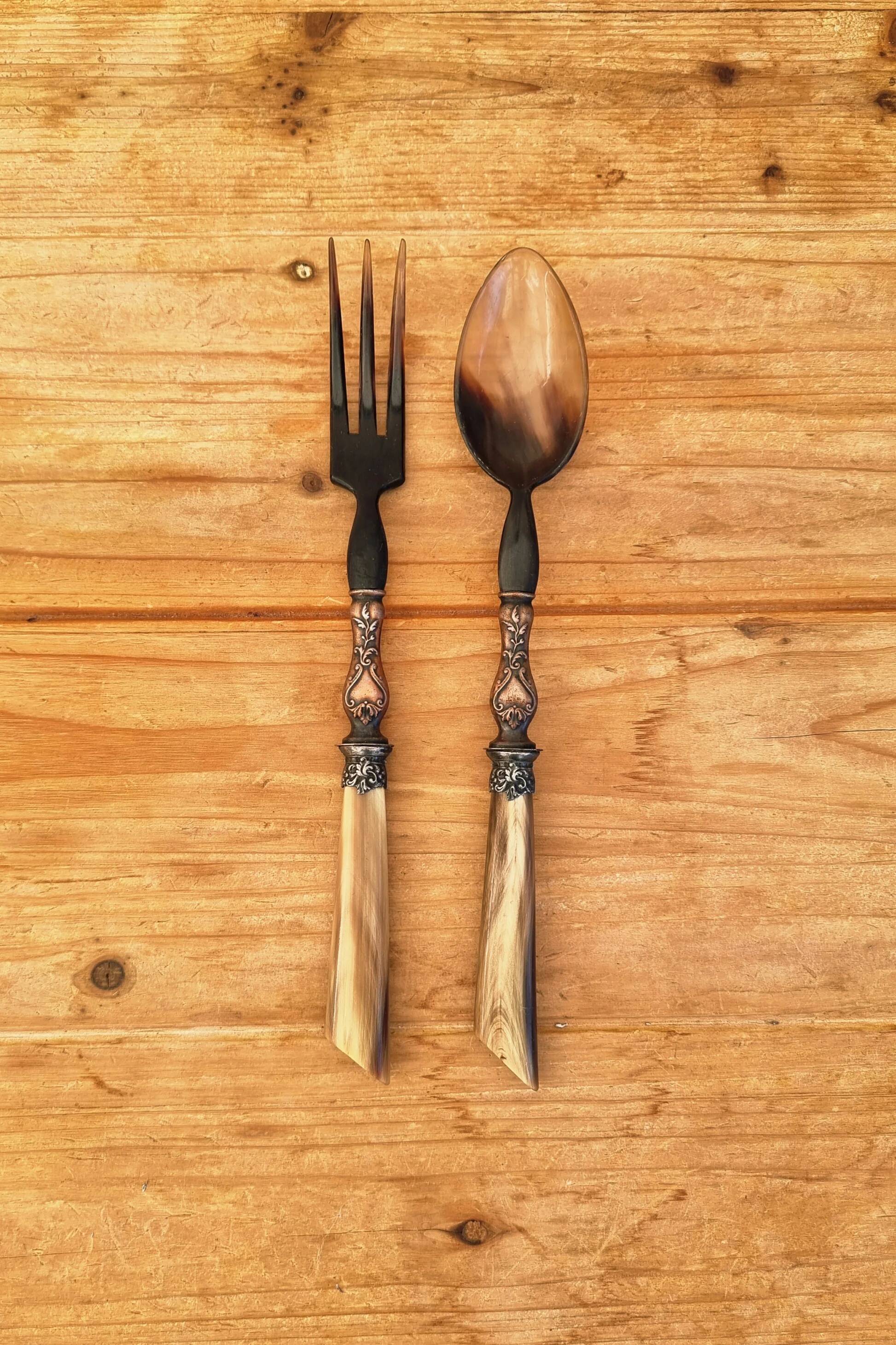 Vintage serving cutlery in horn and wrought metal