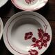 A set of 4 mismatched Art Deco red blue soup plates