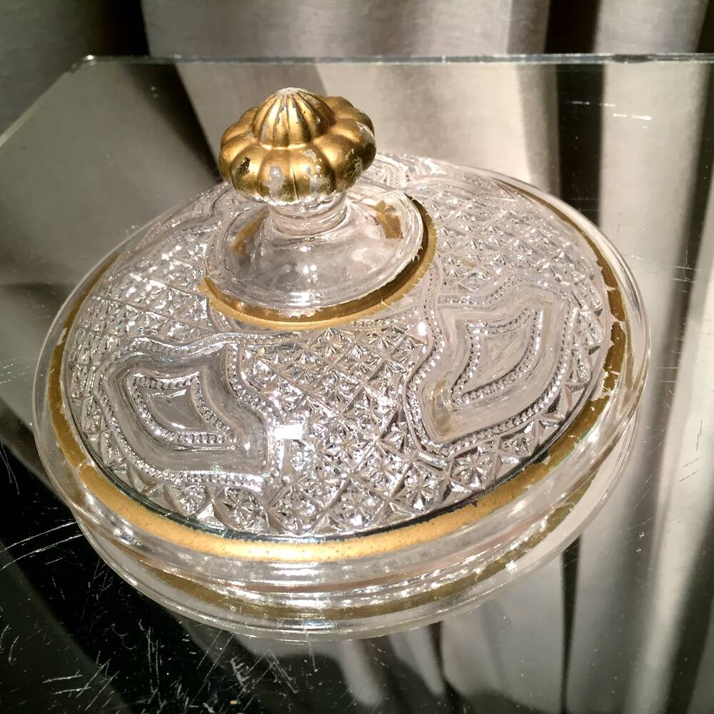Butter dish or candy dish in pressed glass molded with golden rim