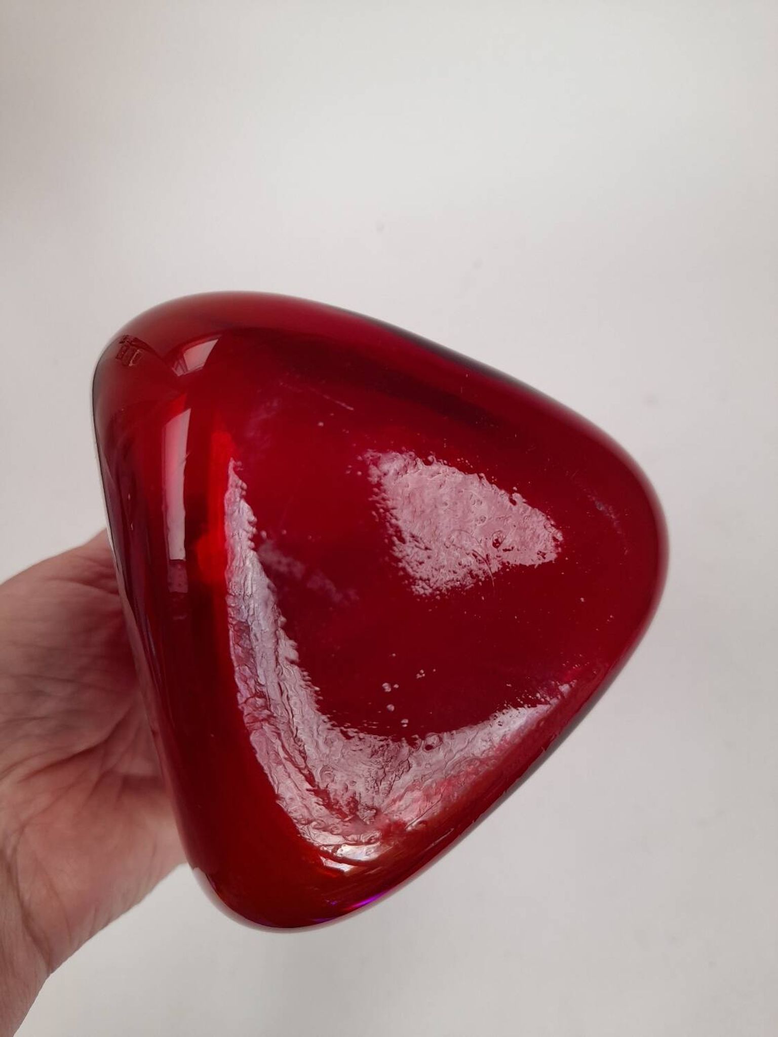Triangular red glass vase by Gunnar Ander for Elme Glasbrück.