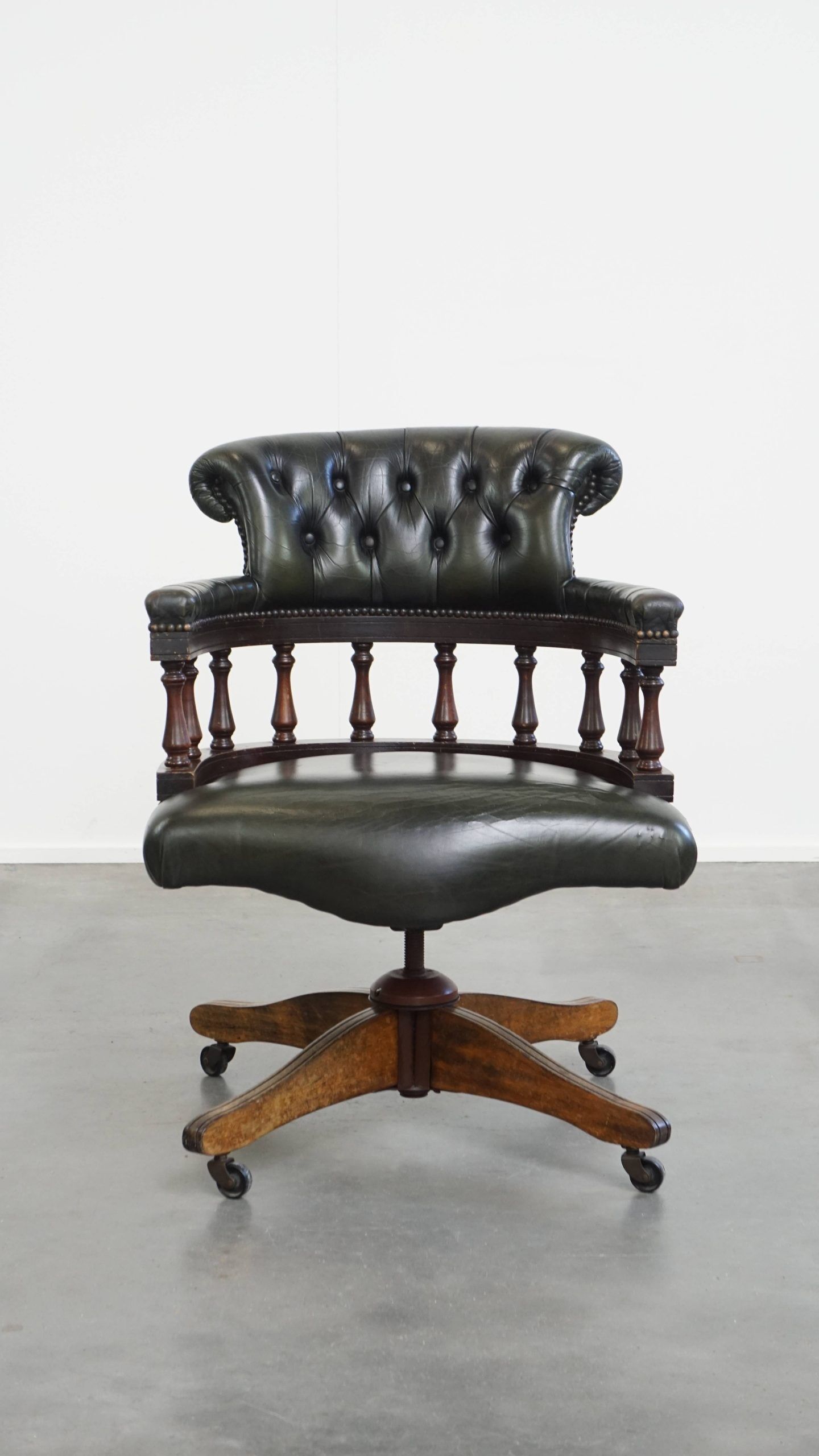 Adjustable green leather and wood Chesterfield office chair with swivel
