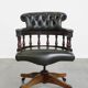 Adjustable green leather and wood Chesterfield office chair with swivel