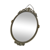 Oval mirror in gilded brass