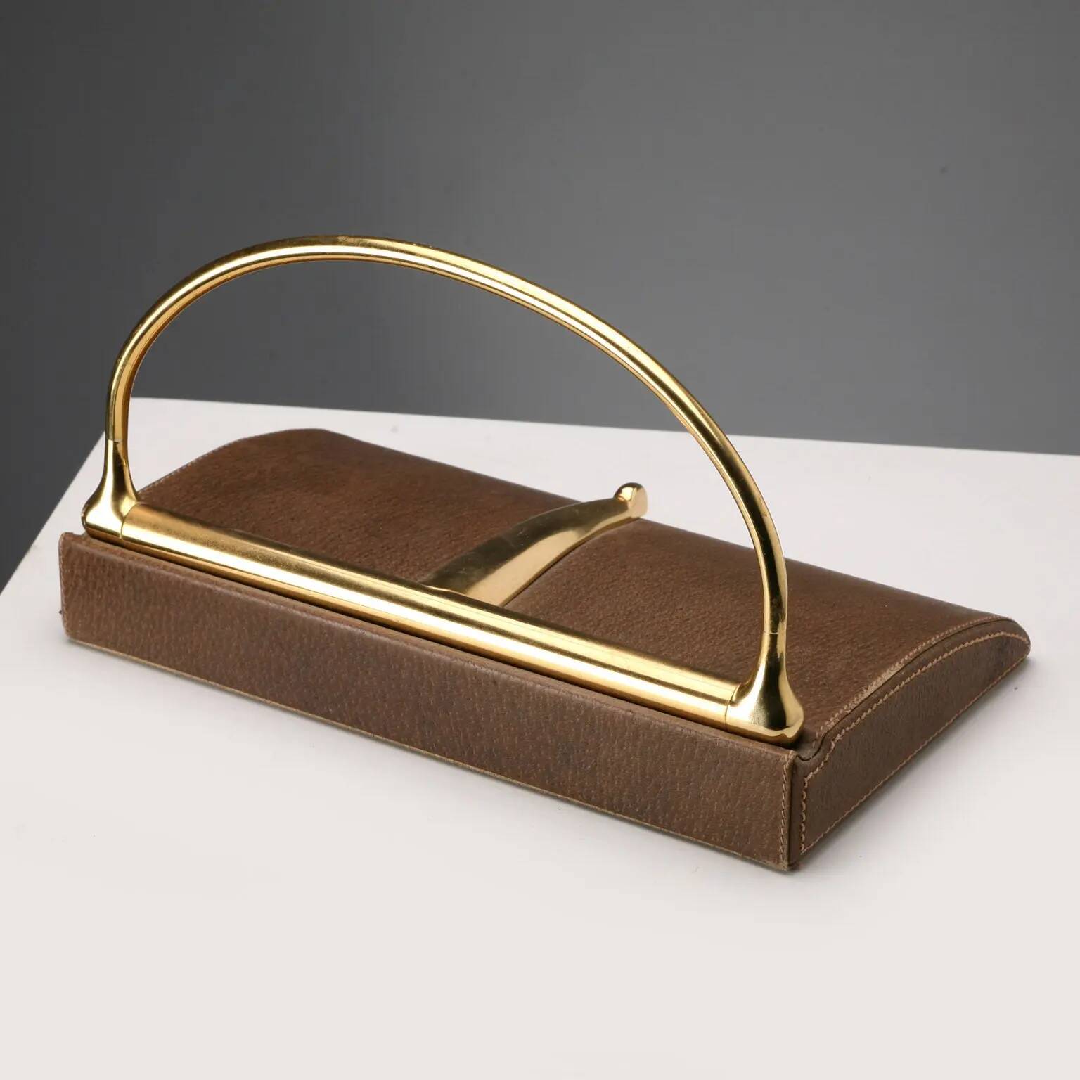 Vintage Gucci bookends in leather and brass, Italy, 1970s.