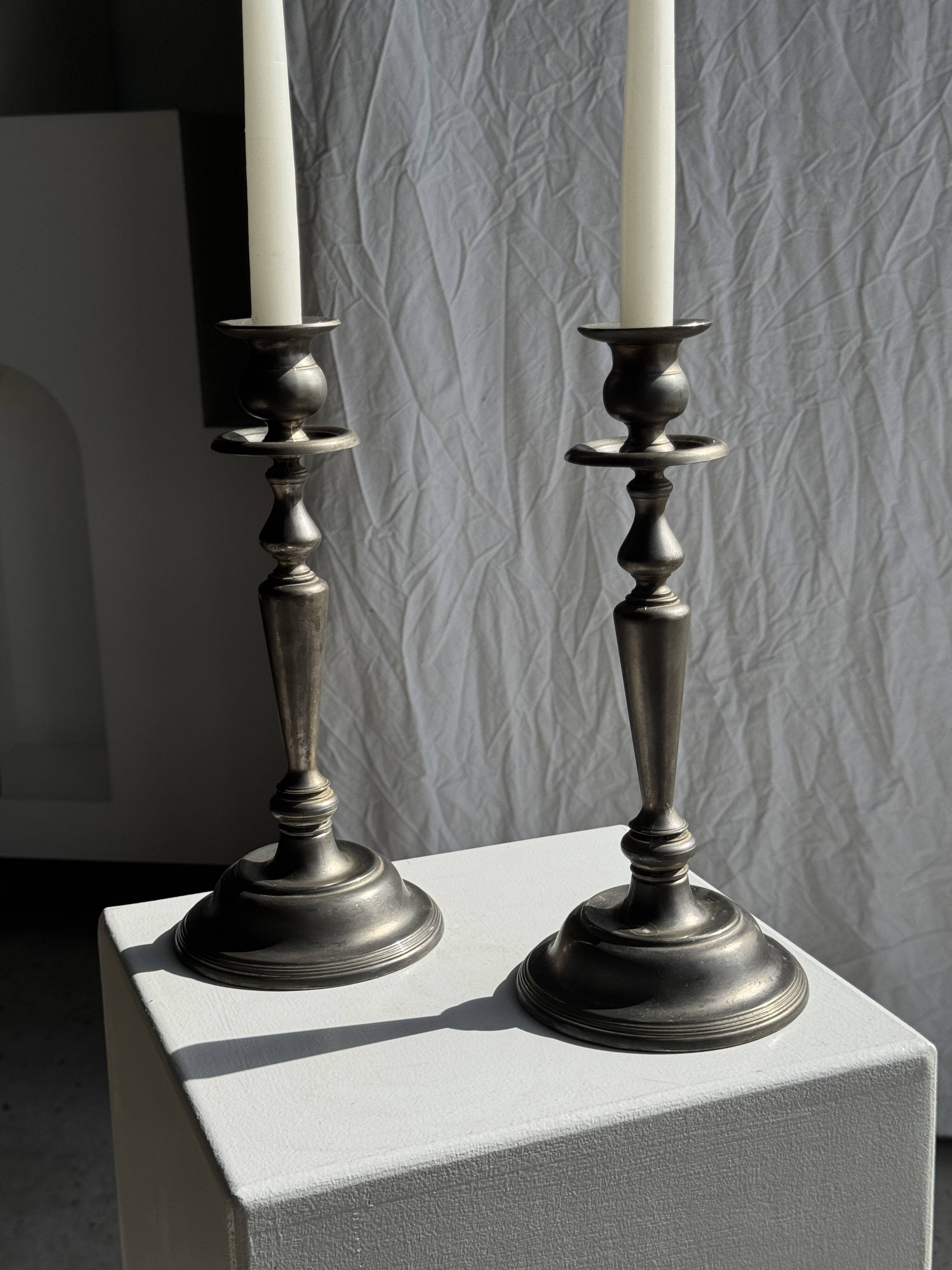 Two large antique silver-plated metal candlesticks, H30