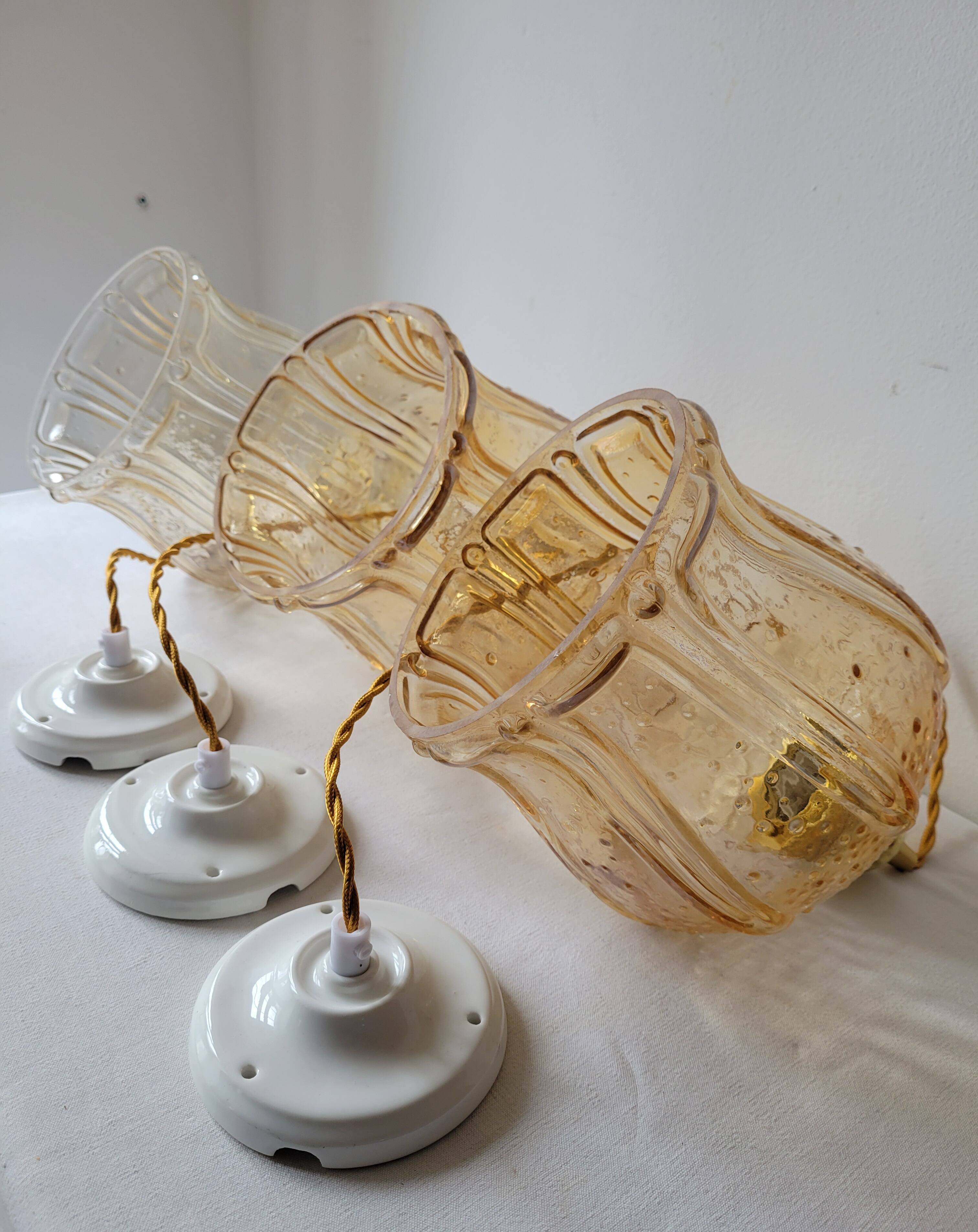 Trio of amber glass pendant lights