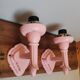 Set of 2 vintage pastel pink enamelled cast iron wall lamps