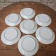 7 dessert plates in porcelain with a violet lilac design and a gold rim.