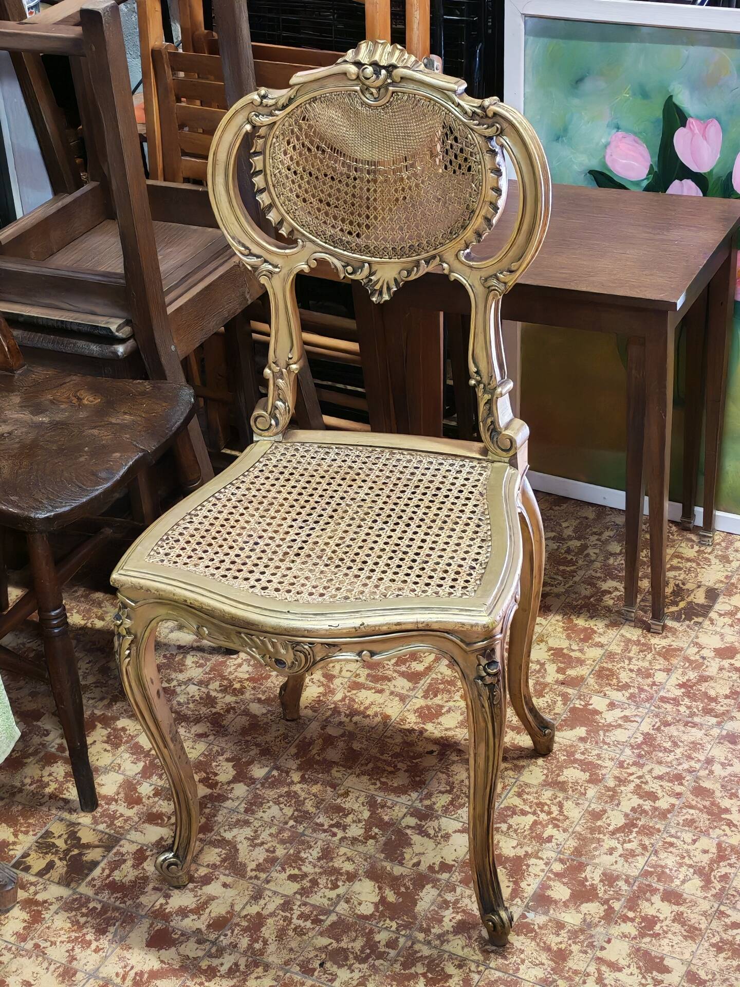 Antique rococo chair in gilded wood and caning