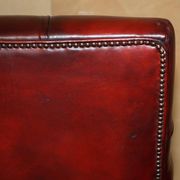 Victorian Chesterfield leather sofa with carved lion heads.