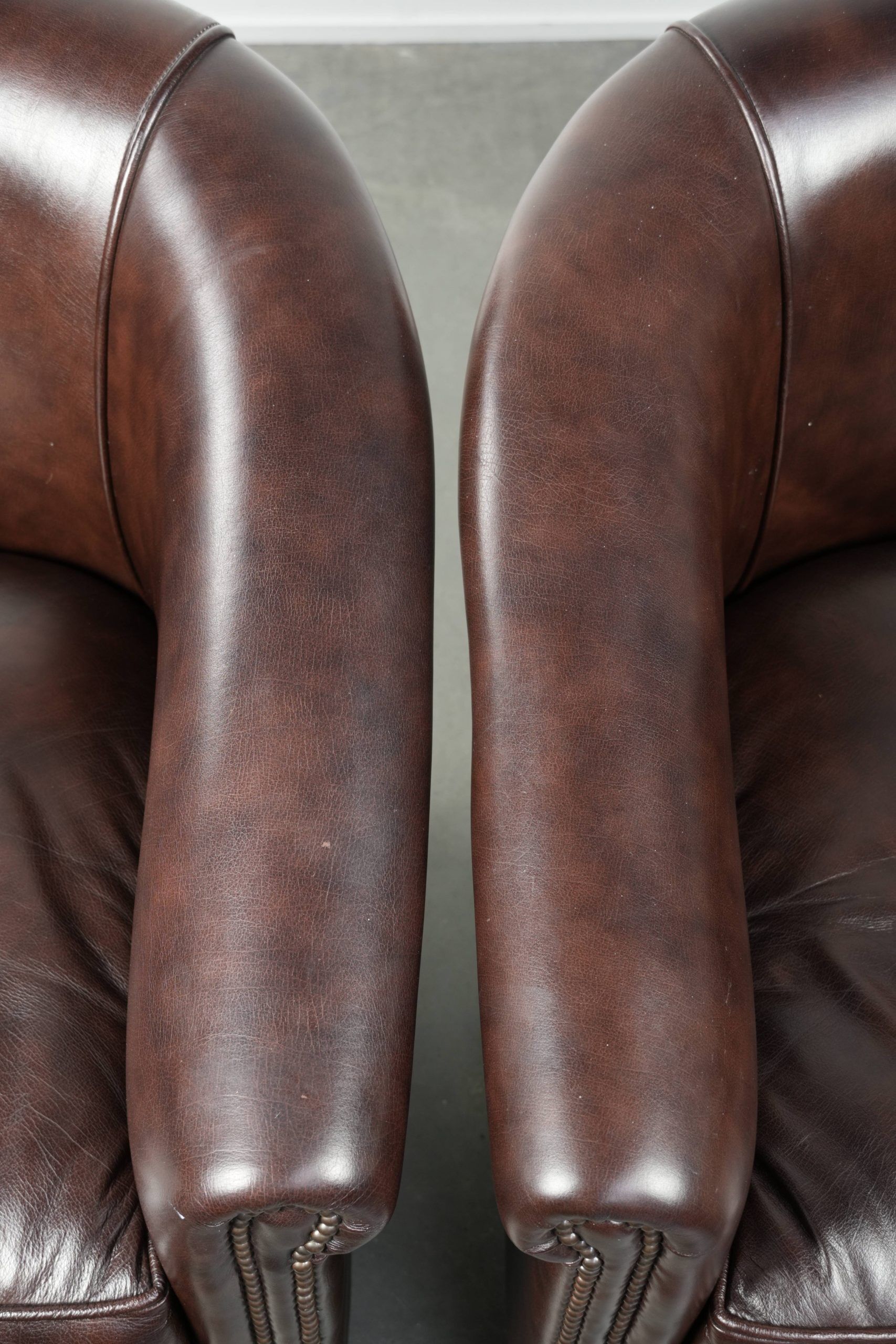 Set of two cowhide club armchairs in good condition with a English design