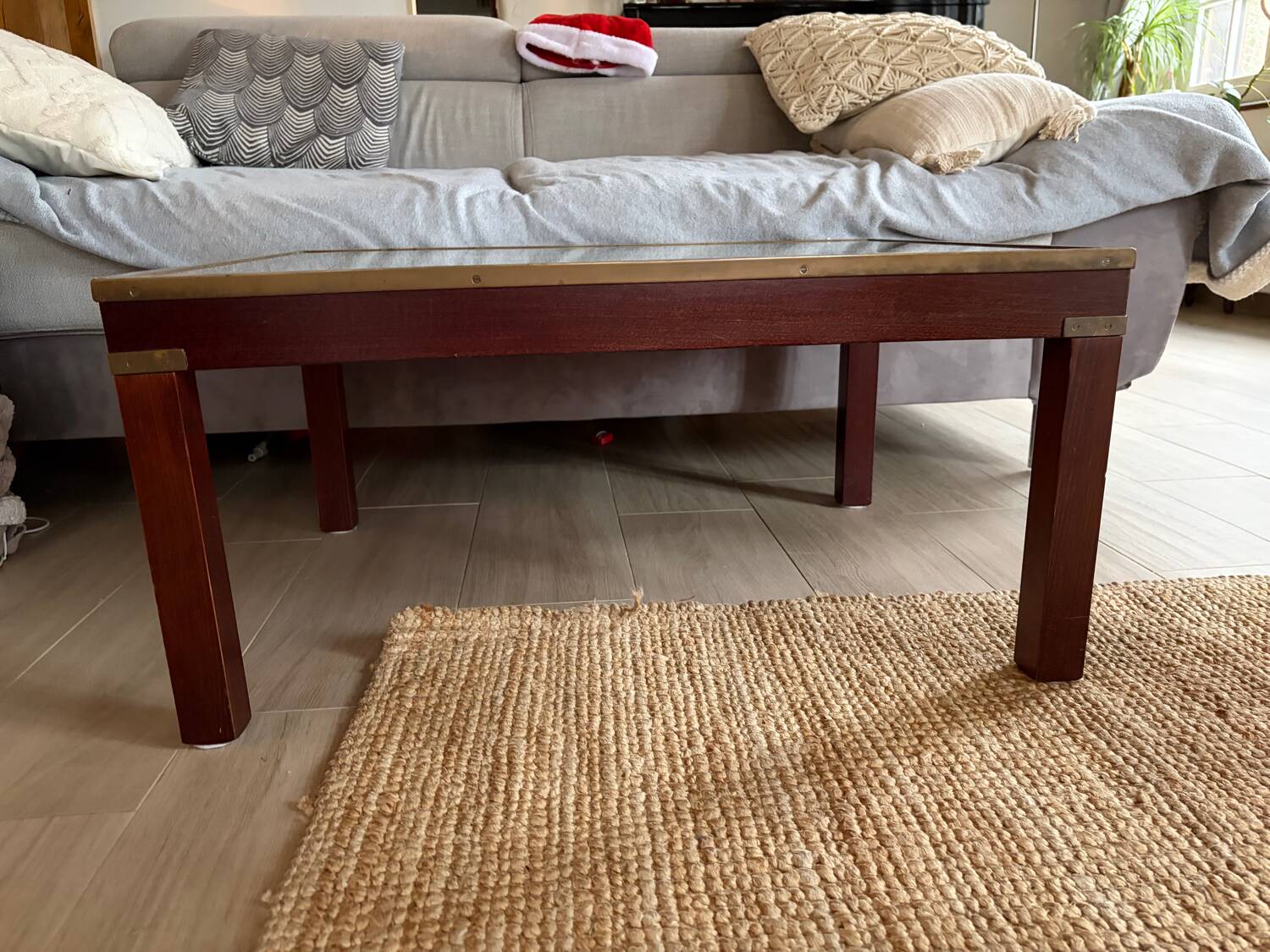 Wood and brass coffee table with a world map under glass.
