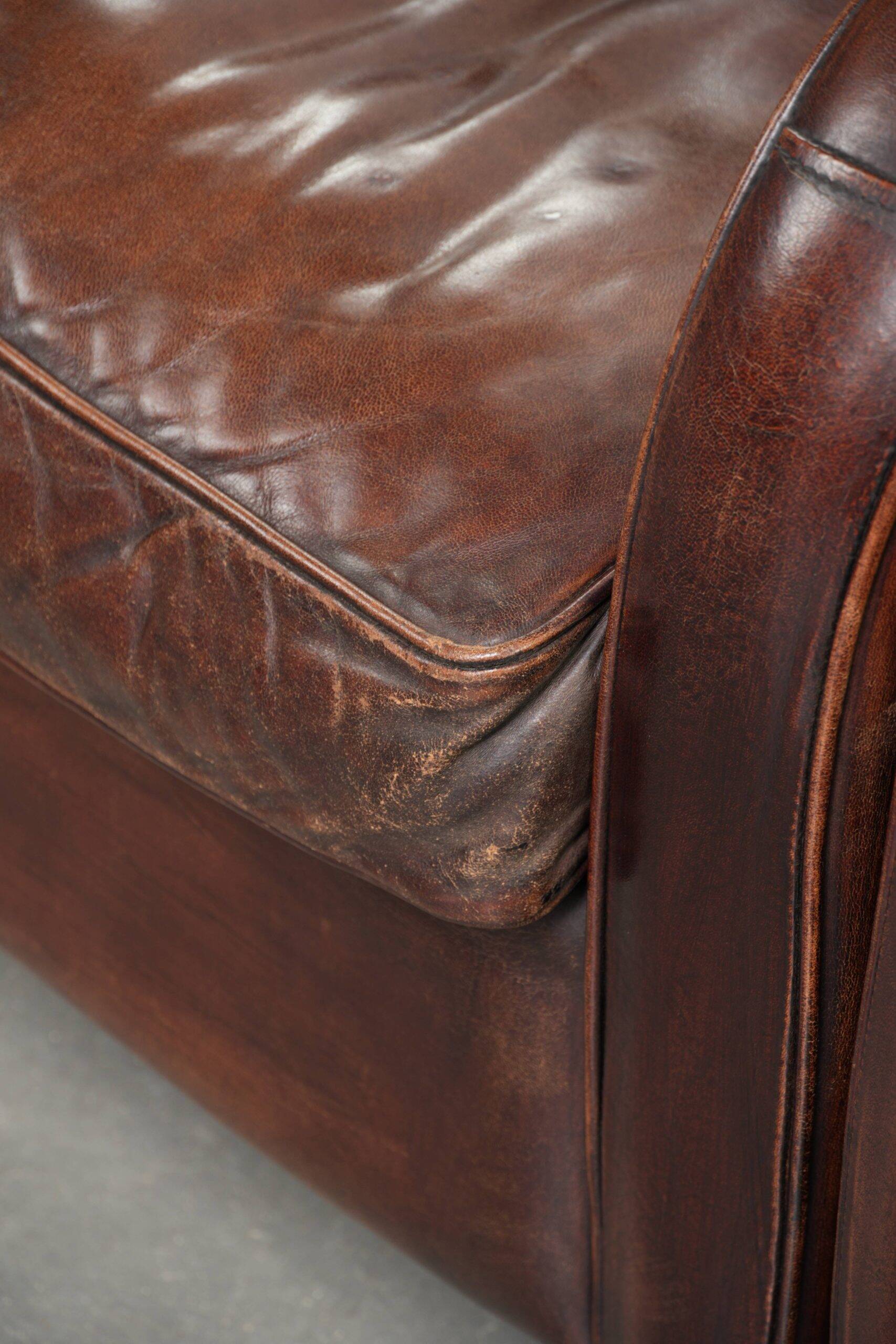 Dark cognac-coloured set of 2 sheepskin armchairs with a sleek design