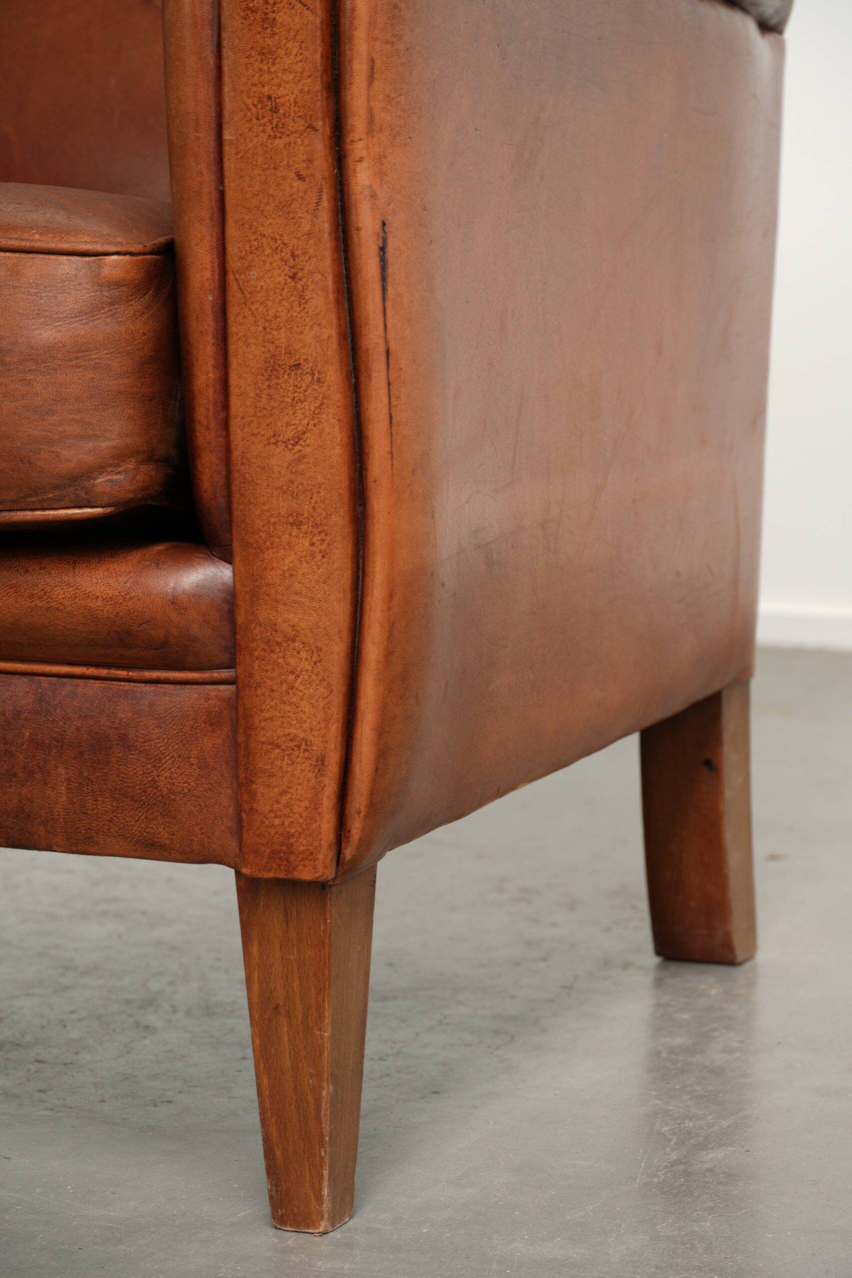 Sturdy vintage sheepskin armchair with a beautiful cognac colour