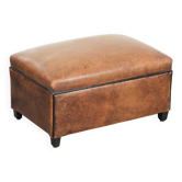 Characterful sheepskin footstool/ottoman finished with black piping