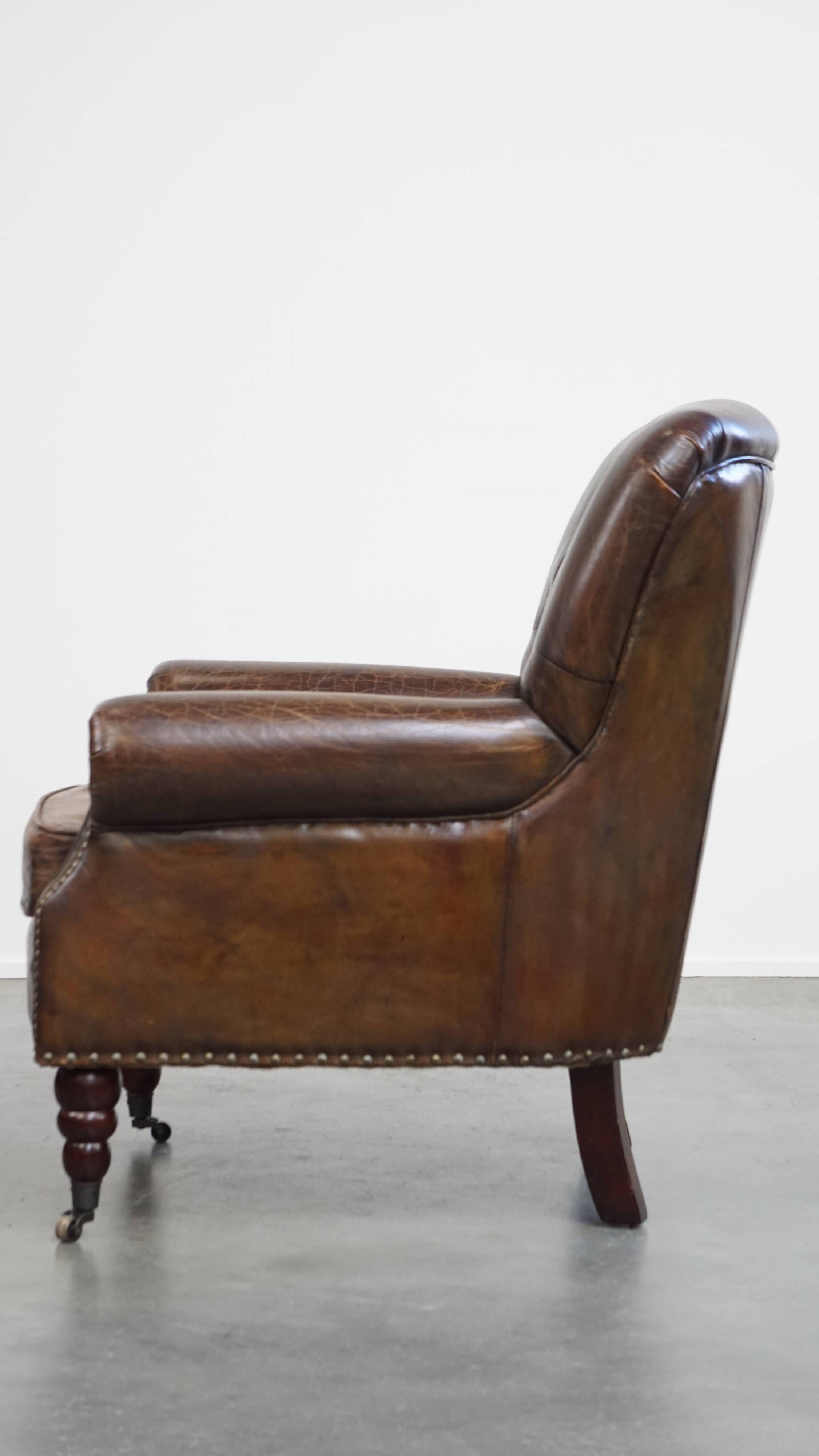 Cognac colored brown grained cowhide chesterfield armchair