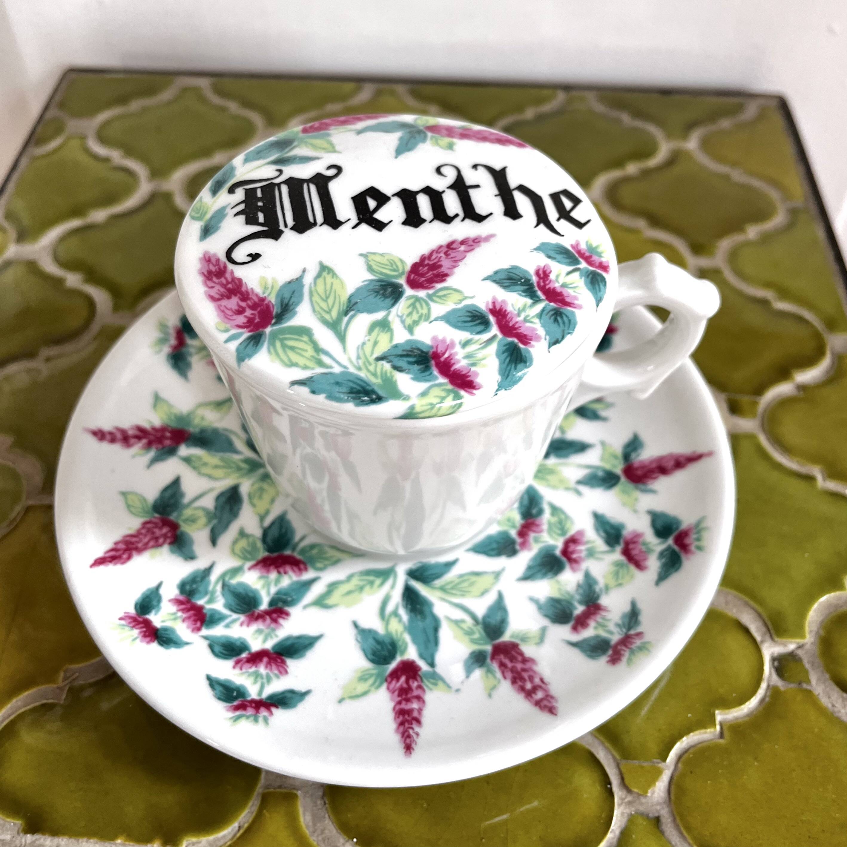 Antique herbal tea cup with mint infusion