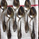 A set of 6 silver-plated metal soup spoons with foliage design.