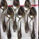 A set of 6 silver-plated metal soup spoons with foliage design.