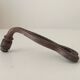 Antique wrought iron door handle with chiselled design.