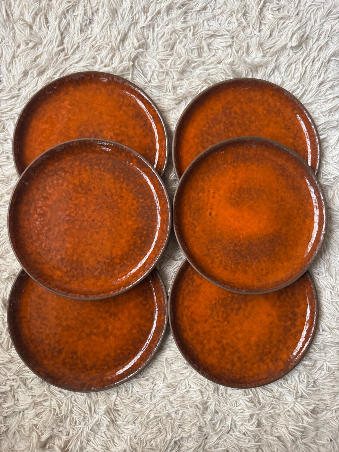 Orange glazed ceramic plates from the 1970s