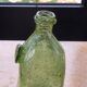 Biot stamped blown glass bottle