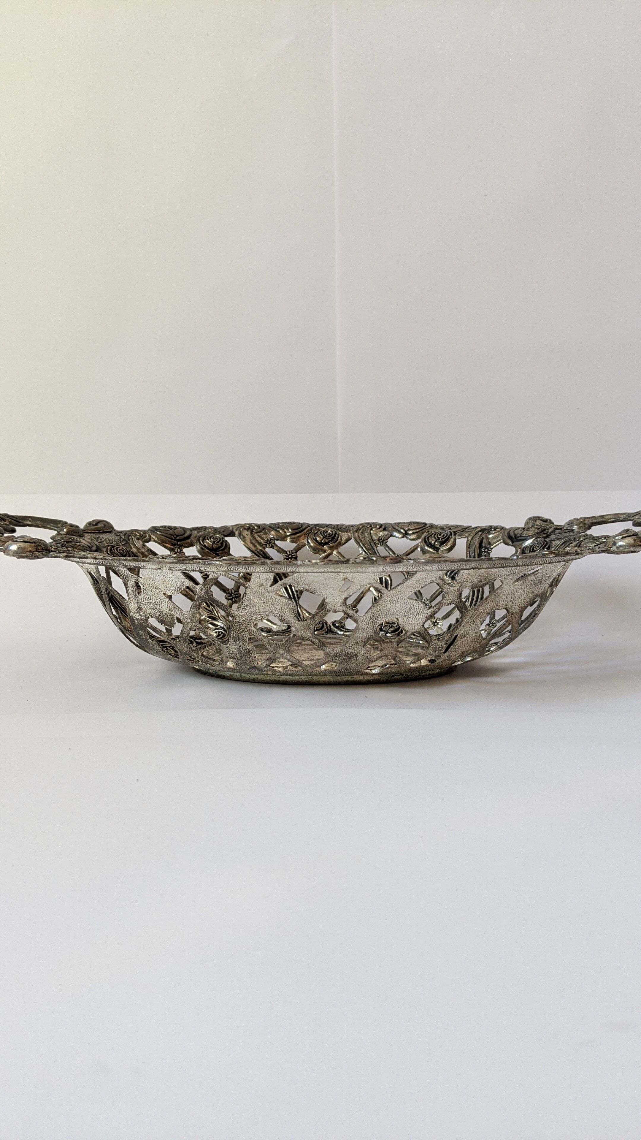 Beautiful silver metal basket with rose decoration