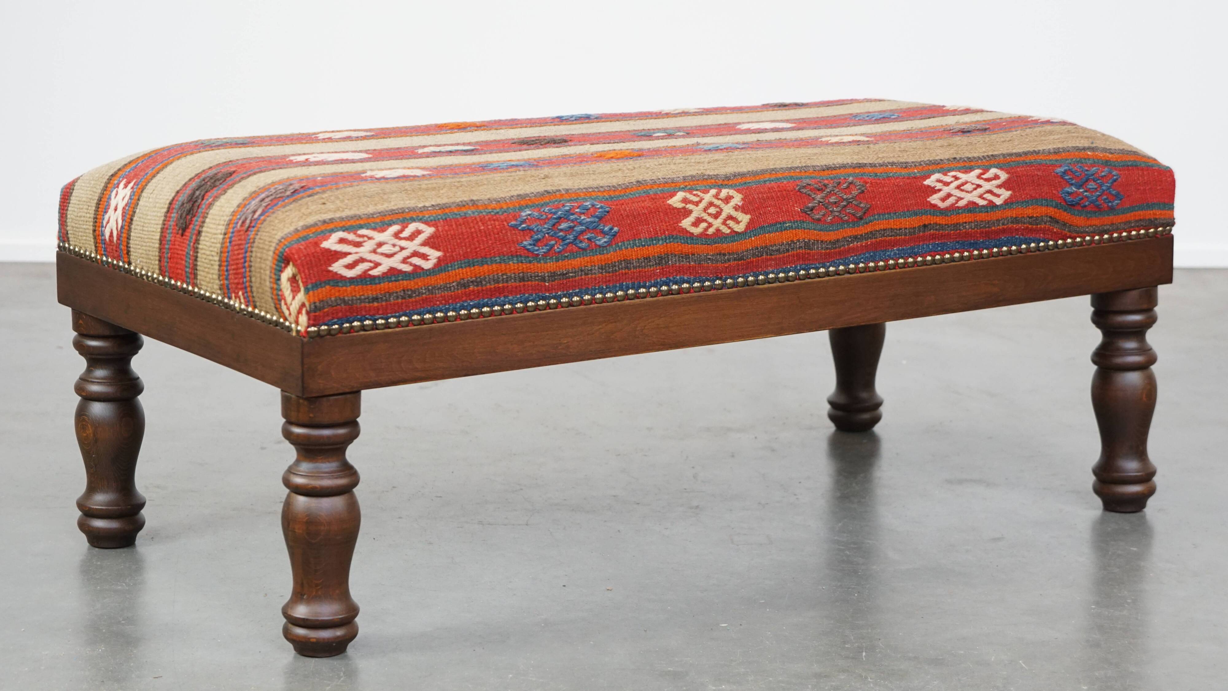 Oriental pouf upholstered in an antique kilim