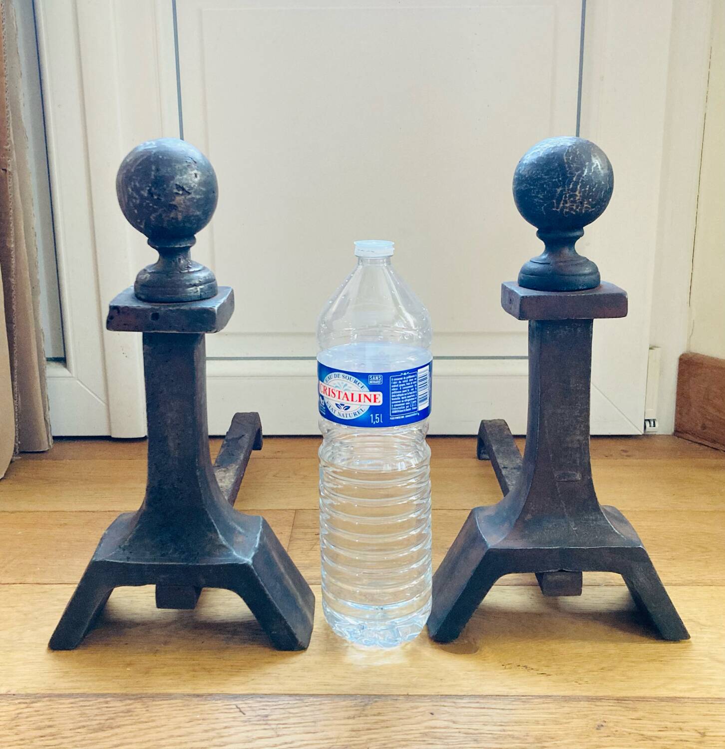 Pair of massive antique-style fire dogs in solid iron from the 20th century.