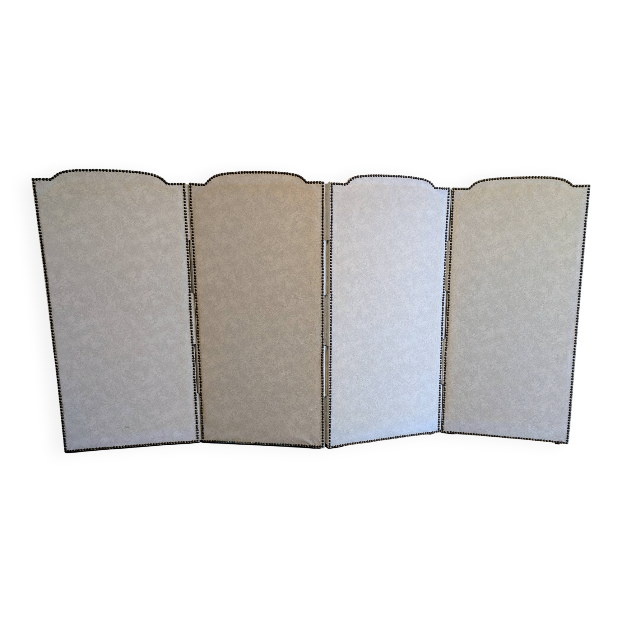 Vintage white faux leather screen with four studded panels, elegant decor.