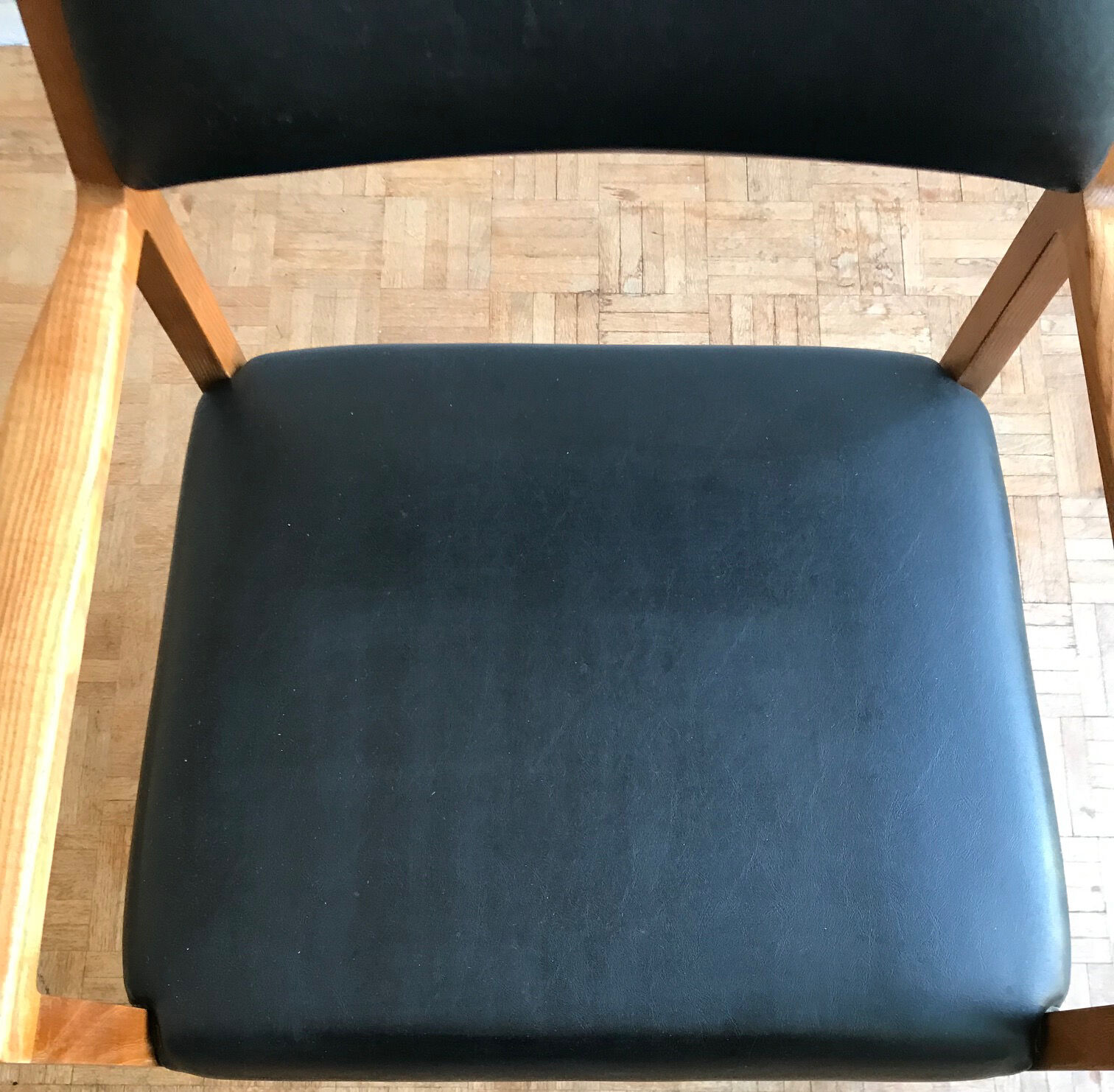 Chair in light teak and black skaï from the 1960s