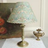 Brass candlestick lamp with its fabric lampshade by William Morris