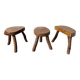 Set of three rustic solid wood tripod stools.