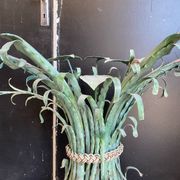 Vintage console in patinated metal with reed leaves.