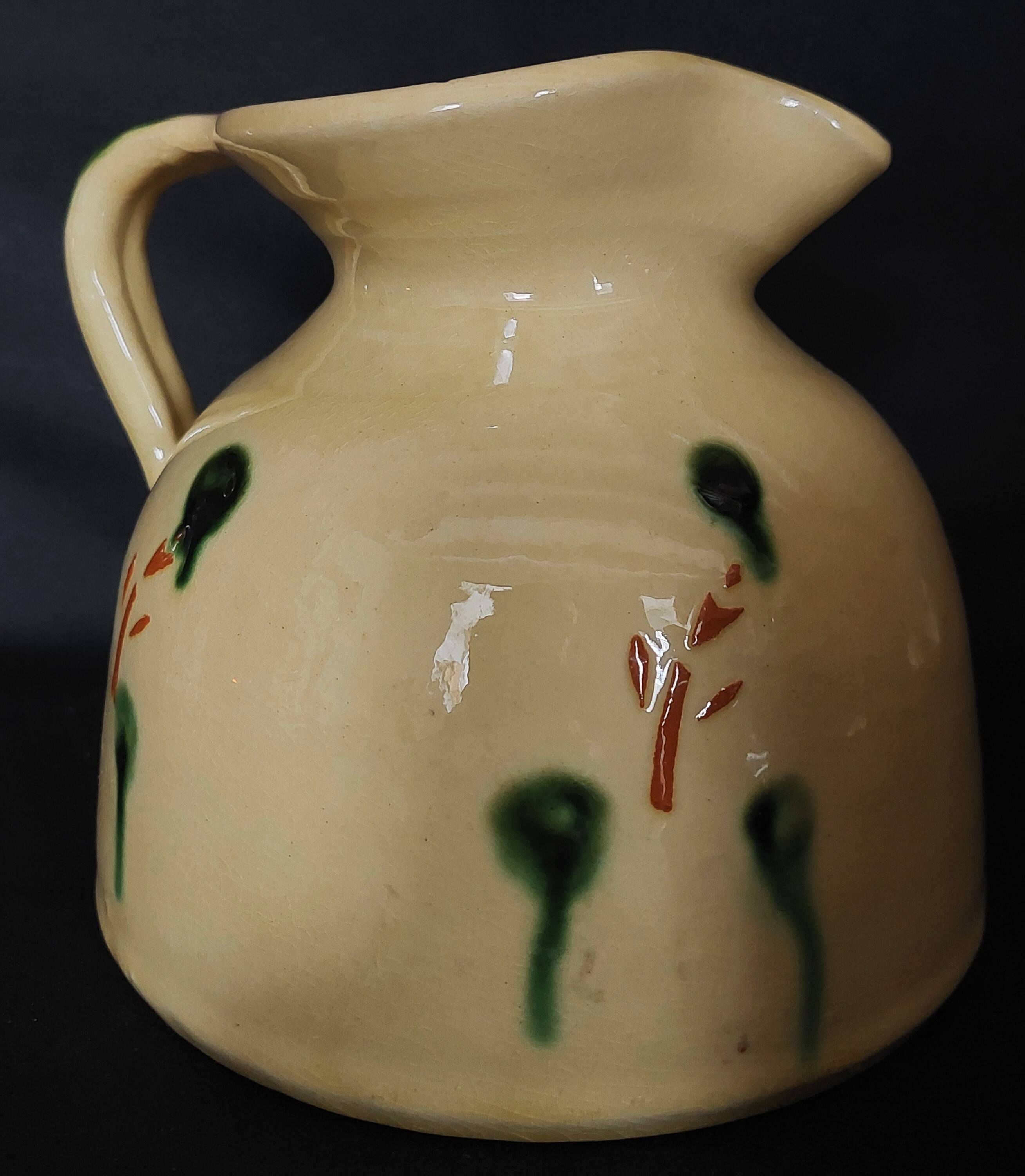 Vintage glazed terracotta ceramic jug from the 20th century.